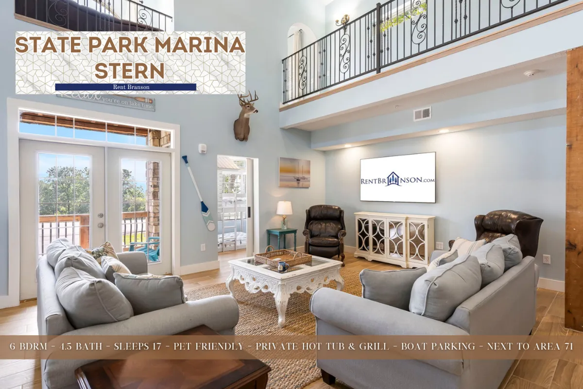 A bright, open living area with large windows allowing plentiful natural light, a comfortable seating area, and a decorative coffee table. Views through the windows suggest spaciousness and a welcoming atmosphere, hinting at the home's connection to the outdoors after a day exploring Branson.